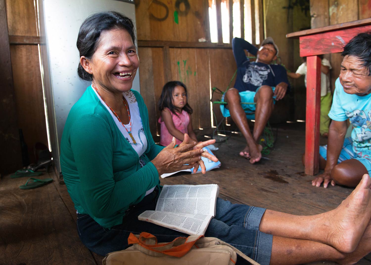 Selmira laughing with a Bible in her lap